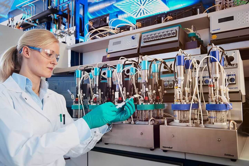 Forscherin im weißen Mantel arbeitet in einem Labor mit erneuerbaren Materialien für PU-Rohstoffe.